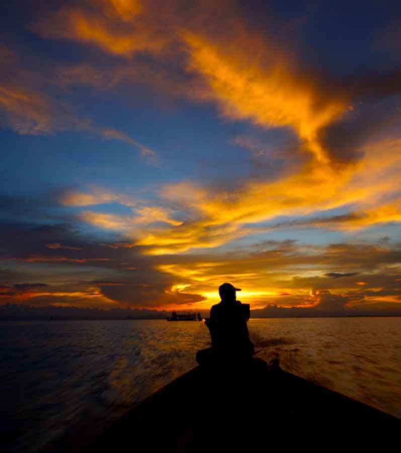 person meditating silhouette sunset sky